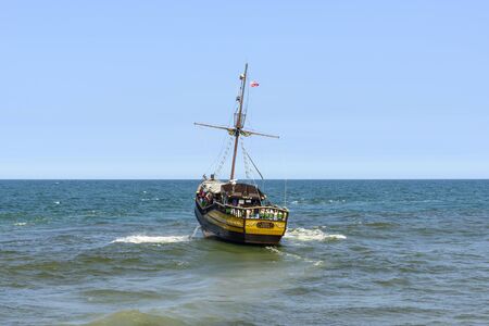 Tourists enjoying the sunny weather and a cruise ship Saba tour on the Baltic sea on 7 July 2015 in...