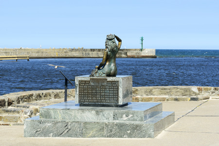 A famous statue of the Mermaid in the harbor entrance is on 7 July 2015 in Ustka, Poland.のeditorial素材