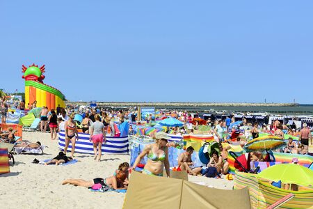 Tourists enjoy the sunny weather and relaxing on the Baltic sea beach on 07 July 2015 in Ustka, Poland.のeditorial素材