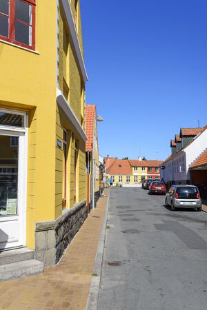 View of a street with the typical old colored houses on 14 August 2015 in Svaneke on Bornholm Island, Denmark.のeditorial素材