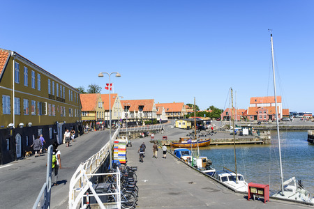 Tourists enjoy the sunny weather and walking along the quay at the port on 14 August 2015 in Svaneke on Bornholm Island, Denmark.のeditorial素材
