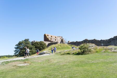 Tourists enjoy the sunny weather and visit the ruins of the Hammershus castle ruins on 14 August 2015 on Bornholm Island, Denmark.のeditorial素材