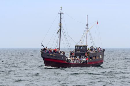 Tourists enjoying the sunny weather and a cruise ship "Santa Maria" tour on the Baltic Sea on 12 August 2015 in Kolobrzeg, Poland.のeditorial素材