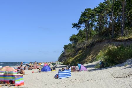 Tourists enjoy the sunny weather and relaxing on the Baltic sea beach on 13 August 2015 in Rewal, Poland.のeditorial素材