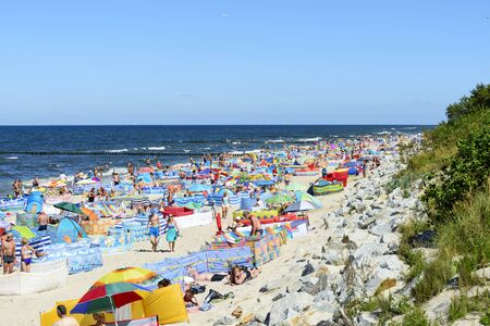 Tourists enjoy the sunny weather and relaxing on the Baltic sea beach on 13 August 2015 in Rewal, Poland.のeditorial素材