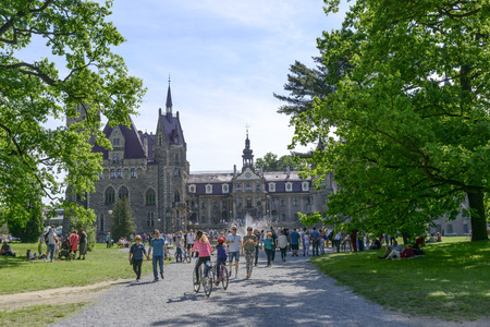 View of the Thiele-Winckler Palace from the park on 22 May 2016 in the district Moszna, Poland. Tourists enjoying the beautiful weather visit the palace in Moszna.のeditorial素材