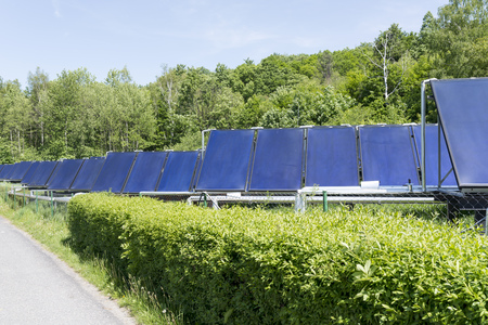 Solar water heaters on green meadow in the mountains Opava. Europe.