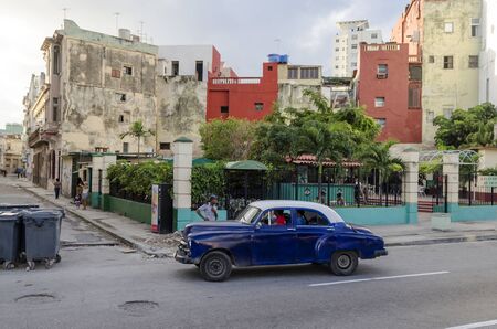 American classic car goes down the street on 28 November 2015 in Havana, Cuba. Brightly colored vintage American cars are very popular in Havana.のeditorial素材