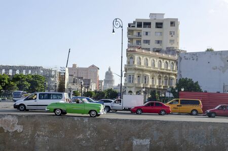 American classic cars driving on the street on 28 November 2015 in Havana, Cuba. Brightly colored vintage American cars are very popular in Havana.のeditorial素材