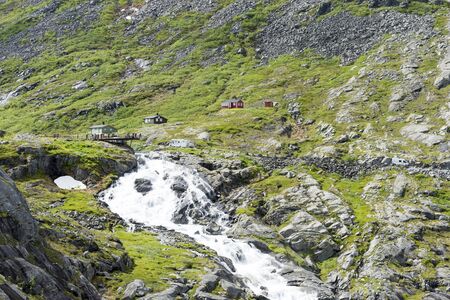 Tourists on a viewing platform near the Trollstigen road between the mountains on June 29, 2016 in Geiranger, Norway.のeditorial素材