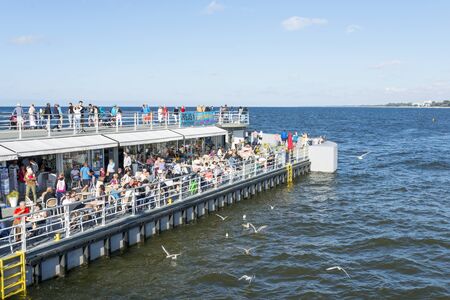 Tourists enjoy the sunny weather and walk along the pier on 15 August 2016 in Kolobrzeg, Poland.のeditorial素材