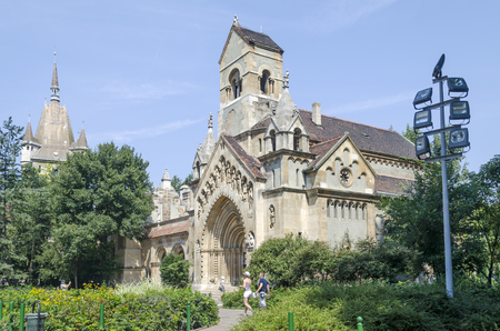 Tourists enjoying the beautiful weather visit Chapel in castle Vajdahunjad on August 9, 2015 in Budapest, Hungary. Vajdahunyad Castle is located in the City Park.のeditorial素材