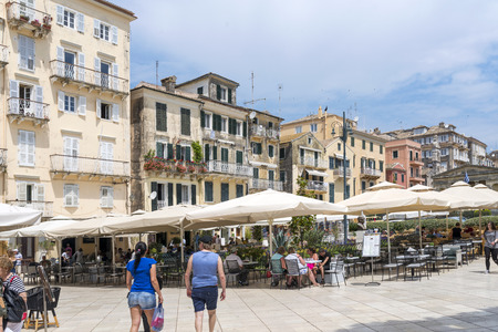 Residents and tourists on the old colorful street on May 23, 2017 in Kerkyra, Corfu island in Greece.のeditorial素材