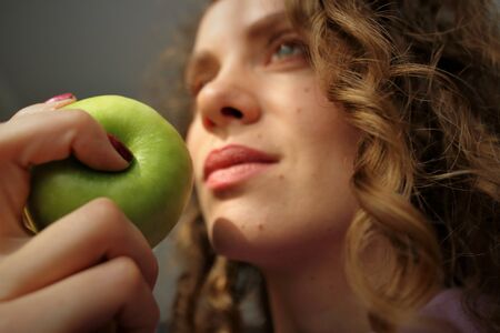 Beautiful girl holding a green Appleの写真素材