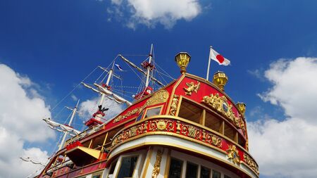 Red ship with Japan flag and blue sky.の写真素材
