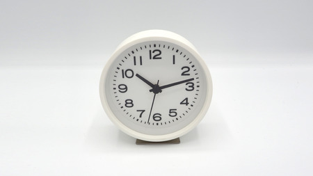 White clock with minute hand and hour hand on white background.