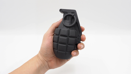 Man left hand and military bomb and white background.の写真素材