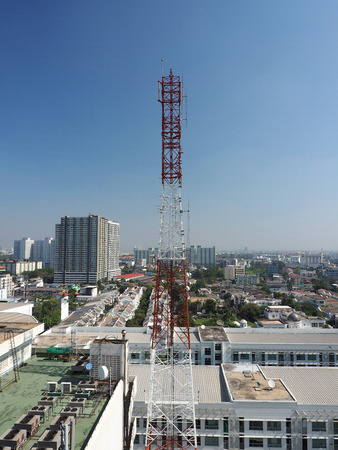 Telecommunication tower red and white color and blue sky.の写真素材
