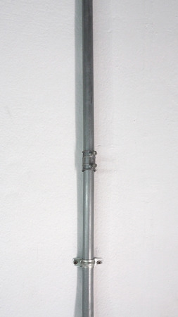 Old silver steel pipe and white texture wall and shadow.の写真素材