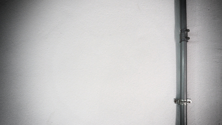 Old silver steel pipe and white texture wall and shadow.の写真素材
