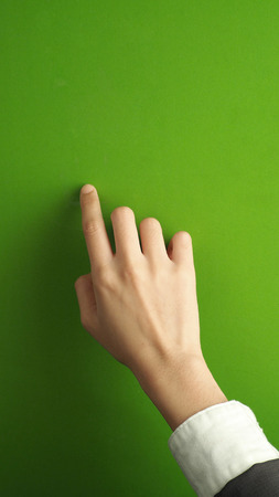Woman finger and hand and touching on green screen background.の写真素材