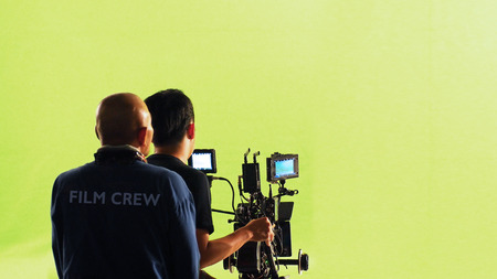Photographer team and film crew and movie camera and green screen studio.の写真素材
