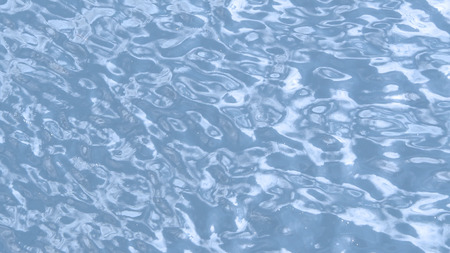 Blue water waving and top view of river and dirty river and reflex of sun.の写真素材