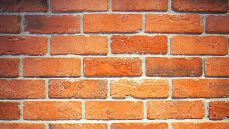 Red brick wall and old dirty rough surface texture close-up.の写真素材
