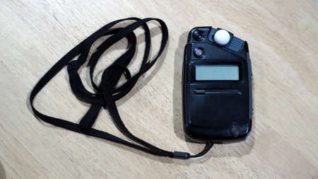 Light meter black color on the wood texture table and top view angle.の写真素材