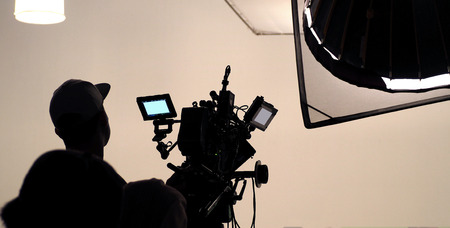 Behind the scene of tv movie video film shooting production crew team and camera lighting set in the big studio.の写真素材