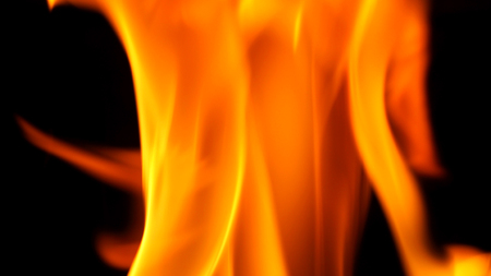 Fire blazing while cooking on black color background and close-up shot.