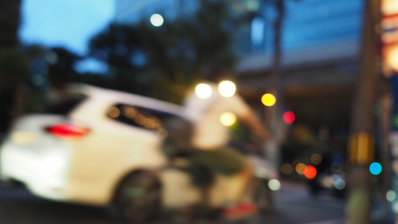 Blurry image of city street life in evening of Osaka Japan and colorful bokeh effect lights.の写真素材