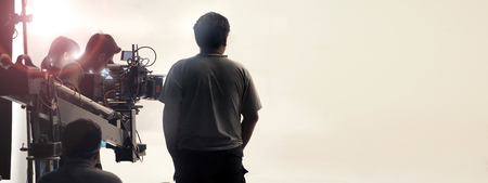 Behind the scenes of video shooting production crew team and professional camera equipment in...