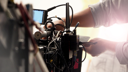 Behind the 4k high defination video camera shooting by film crew team in big studio production.