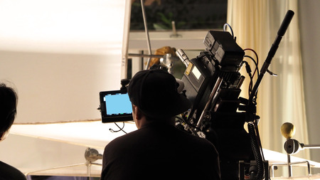 Behind the scenes of filming video commercial in the big studio and production crew team are working.の写真素材