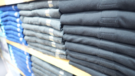 Clothes or shirt and hanger on shelf in store for sale and close-up angle view. 