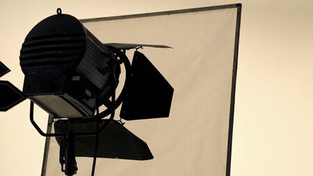 Big studio flash light on tripod and soft box paper in large size studio for video or film production.の写真素材