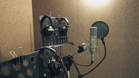 Microphone with pop filter and shock mount anti-vibration and note stand and tripod in music score studio productionの写真素材