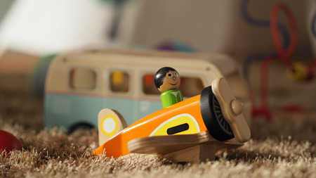 Old vintage wood toys for baby or kids on light brown color carpet which have a airplane bus ball and others.の写真素材