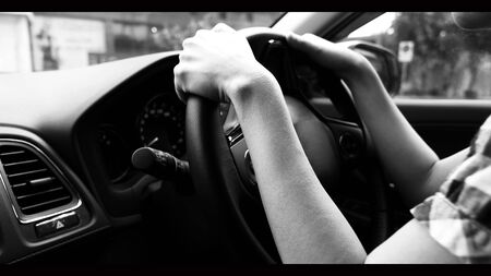 Close-up images of woman hands driving and controling car with confidence and safety which car...