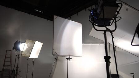 Studio light and back drop and soft box set up for shooting photo or video production which includes flashlight and continue lighting on tripod and paper background and used for photographer or videographerの写真素材