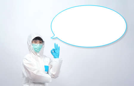 Woman doctor in PPE or personal protection equipment suit and medical mask and glove for protect...