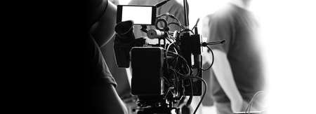 Behind the scenes of video recording or filming online movie by 8K high definition digital camera and professional monitor. And flare lighting set up with film crew team in the studio production.の写真素材