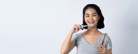 Asian teen facial with braces and smiling to camera to show dental orthodonic teeth which include...