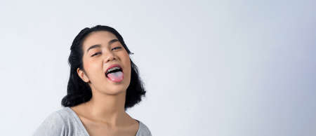 Asian teen facial with braces and smiling to camera to show dental orthodonic teeth which include...