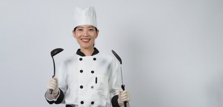 Chef gesturing. Portrait beautiful asian woman cook wearing hat and chef uniform making gesture sign and looking at the camera. Influencer. Cooking class. Copy space. Online food merchant chef.の写真素材