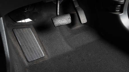 Accelerator and breaking pedal in a car. Close up the foot pressing foot pedal of a car to drive...