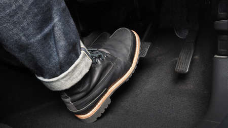 Accelerator and breaking pedal in a car. Close up the foot pressing foot pedal of a car to drive ahead. Driver driving the car by pushing accelerator pedals of the car. inside vehicle.の写真素材