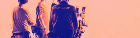 Film Production. Back of videoographer and film crew team with 4k high definetion online video...