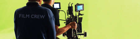 Film Production. Back of videoographer and film crew team with 4k high definetion online video...